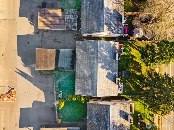 an aerial view of a house with a yard
