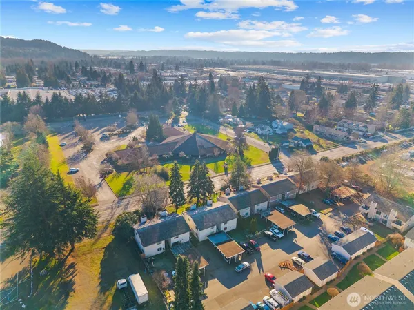 an aerial view of residential houses with outdoor space and swimming pool
