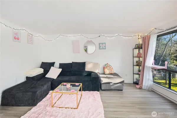 a living room with furniture and wooden floor