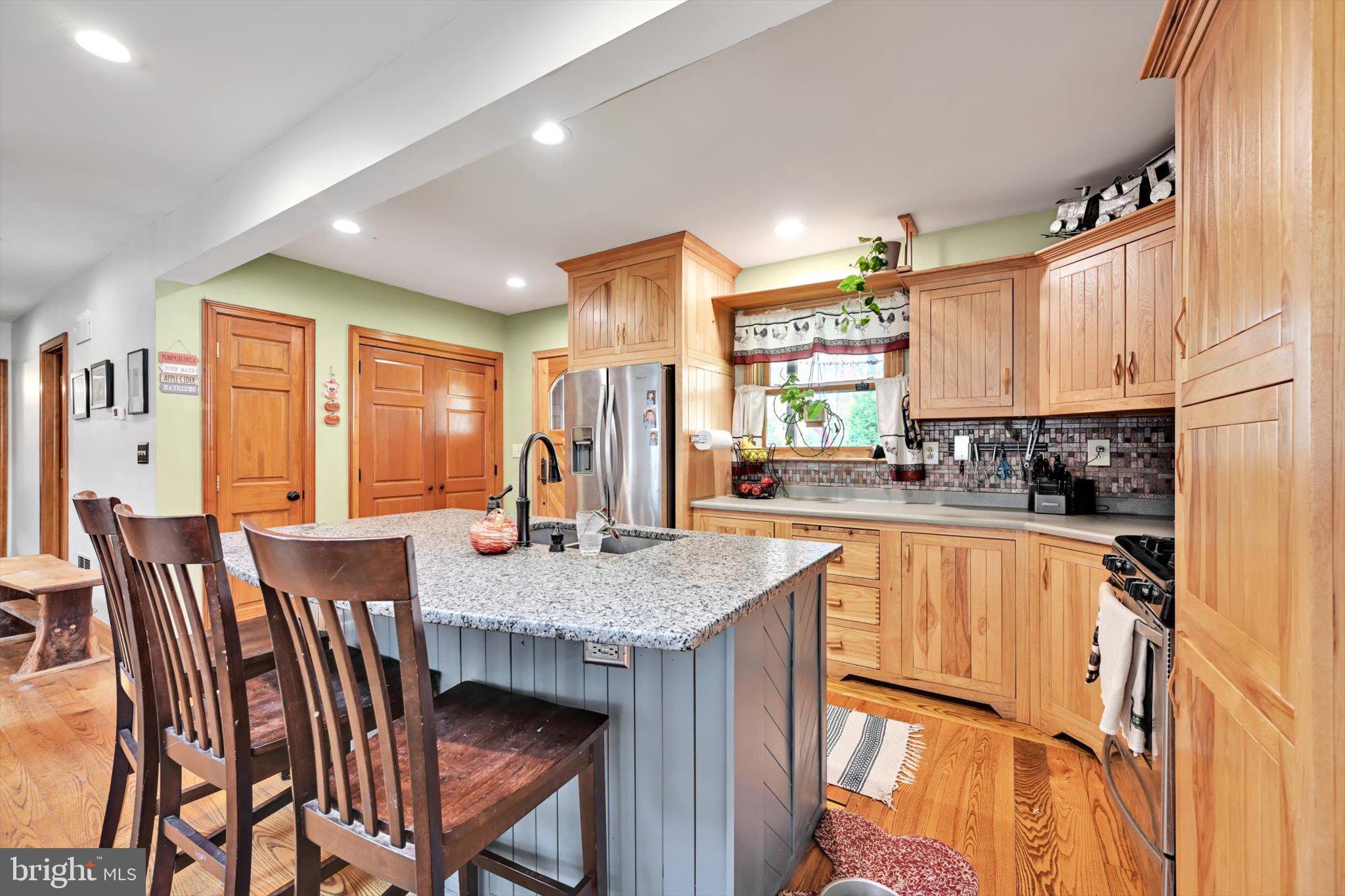 309 Club Road Bethel, PA 19507 - Photo 3 of 49 a kitchen with stainless steel appliances granite countertop table chairs sink and cabinets