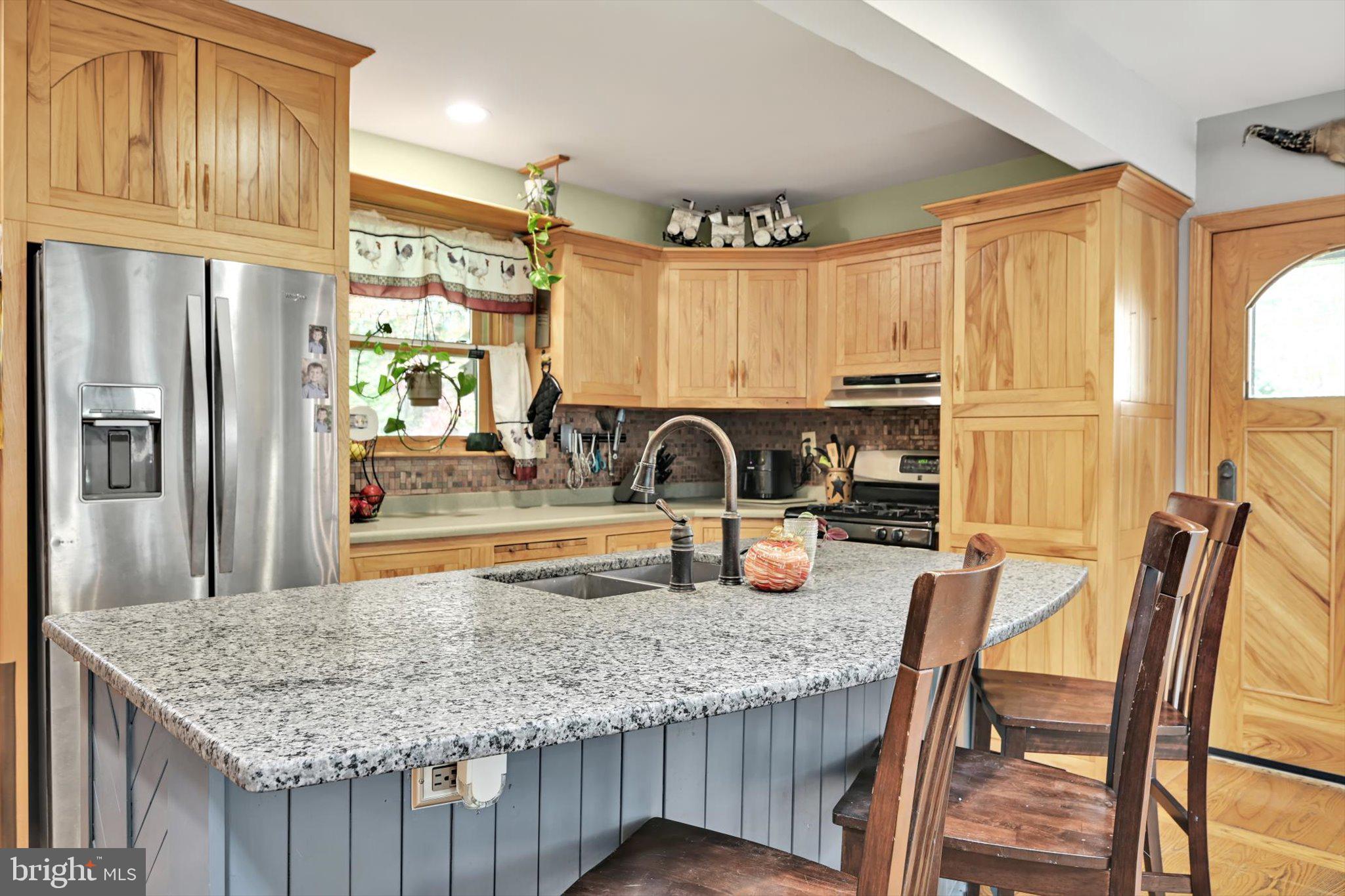 309 Club Road Bethel, PA 19507 - Photo 4 of 49 a kitchen with granite countertop a refrigerator a stove and a sink
