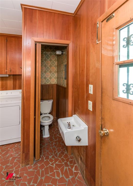 205 7th Street Northeast Springhill, LA 71075 - Photo 6 of 40 Wood-paneled walls with crown molding and mosaic tile flooring