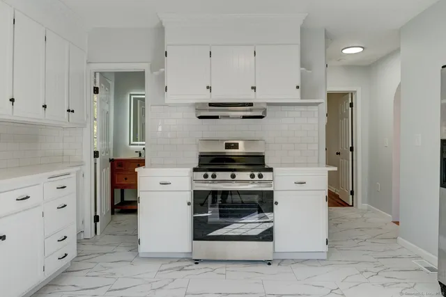 a kitchen with cabinets and appliances