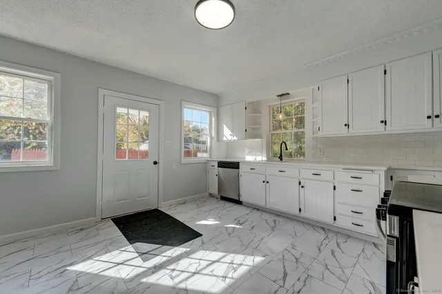 a bathroom with a granite countertop toilet a sink and bathtub