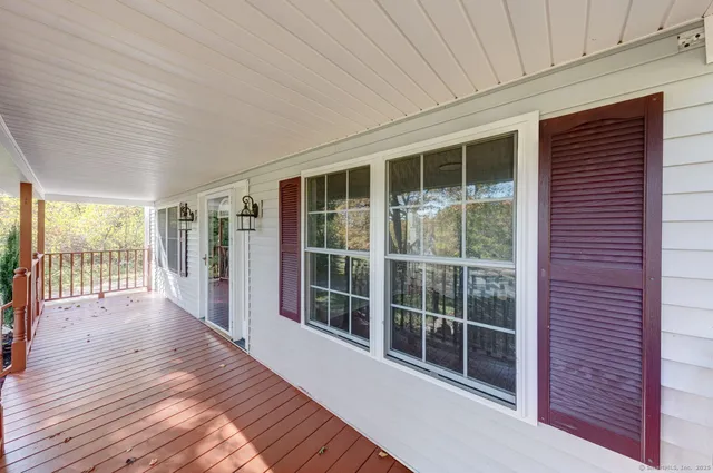 a view of house with outdoor space and trees