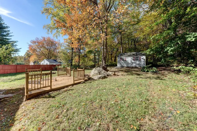 a view of a backyard with wooden fence