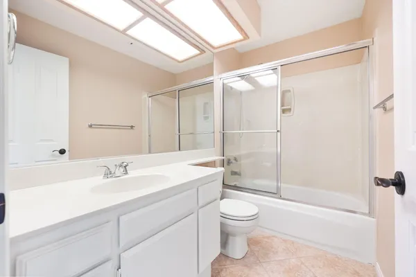 a bathroom with a sink mirror bathtub and toilet