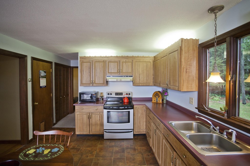 573 Westhampton Road Northampton, MA 01062 - Photo 9 of 30 a kitchen with stainless steel appliances granite countertop a sink stove and refrigerator