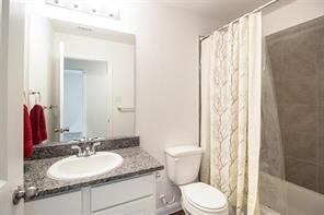 195 Cherry Tree Livingston, TX 77351 - Photo 4 of 8 a bathroom with a granite countertop sink toilet a mirror and a shower