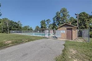 195 Cherry Tree Livingston, TX 77351 - Photo 8 of 8 a view of a house with backyard and trees