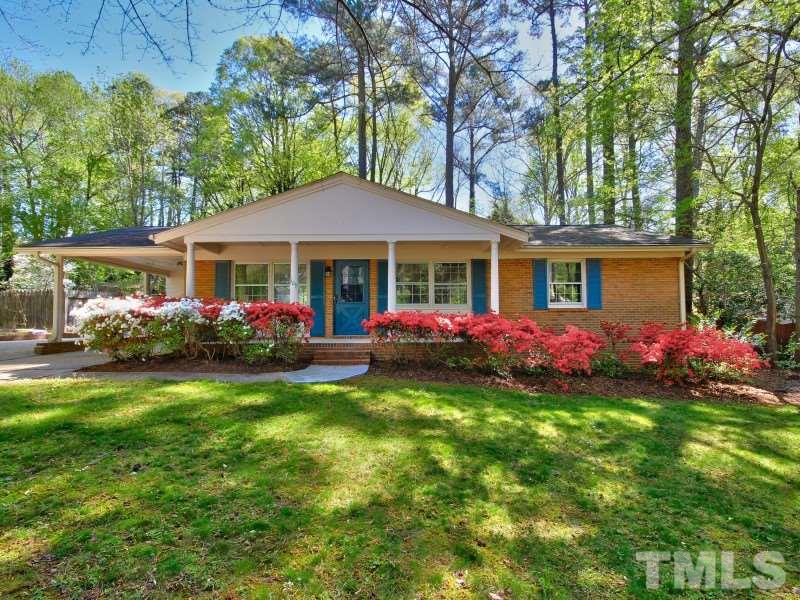 509 Old Farm Road Raleigh, NC 27606 - Photo 2 of 22 Large front yard with beautiful flowers and a rocking chair front porch!