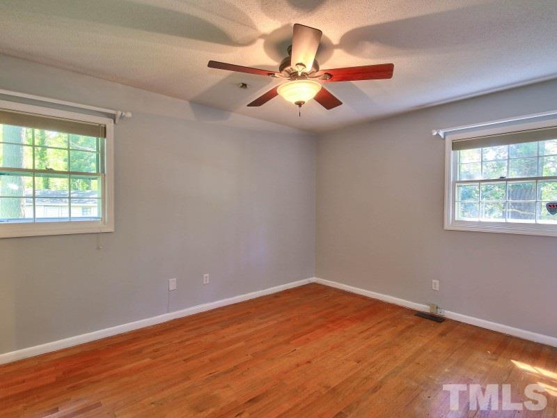 509 Old Farm Road Raleigh, NC 27606 - Photo 11 of 22 Large master bedroom with hardwoods, a walk in closet and en suite bathroom.