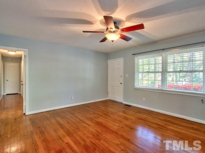 509 Old Farm Road Raleigh, NC 27606 - Photo 6 of 22 Additional view of the main living room with a new ceiling fan and the hardwood floors.