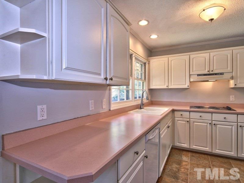 509 Old Farm Road Raleigh, NC 27606 - Photo 9 of 22 Your kitchen includes a pantry, double sink, dishwasher and electric range! Overlooks your spacious and privately fenced in back yard!