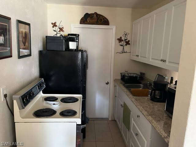 3049 2nd Street Fort Myers, FL 33916 - Photo 6 of 12 a kitchen with a refrigerator stove and sink