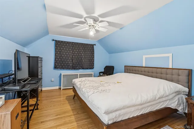a bedroom with a large bed and a flat tv screen on a dresser