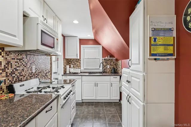 a kitchen with stainless steel appliances granite countertop a stove and a sink