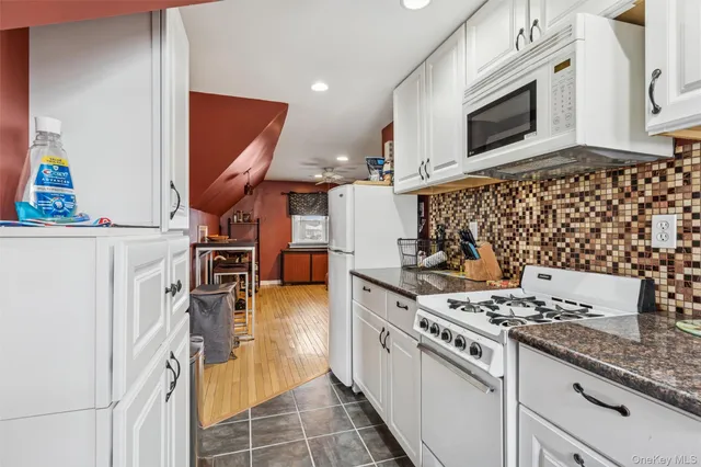 a kitchen with stainless steel appliances granite countertop a stove and a microwave