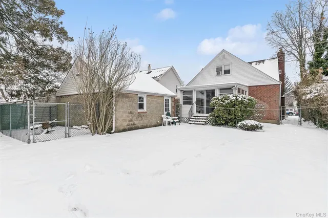 a view of a house with snow in front of house
