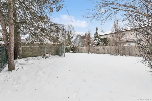 a view of a yard covered in snow