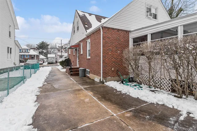 a view of a street with wooden fence