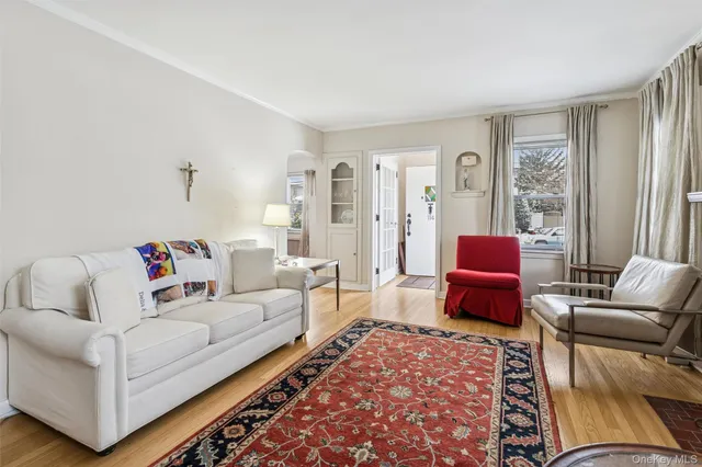 a living room with furniture or couch and two windows