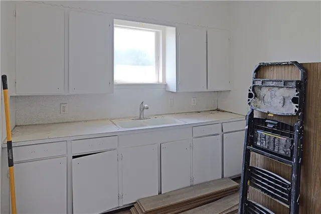 a kitchen with sink and cabinets