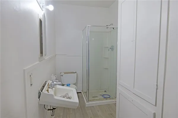 a bathroom with a sink toilet and shower