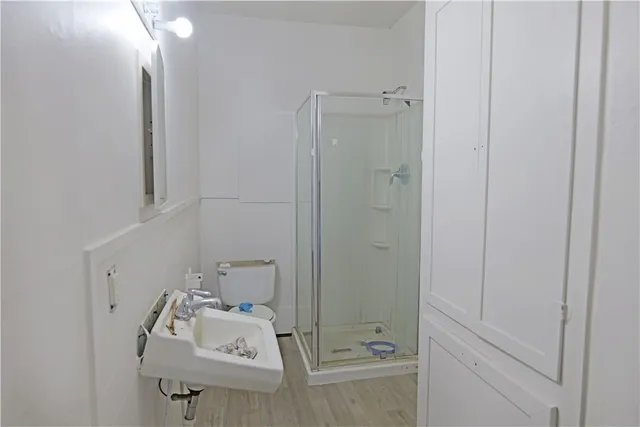 a bathroom with a sink toilet and shower