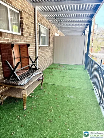 a view of backyard with a chair and a grill