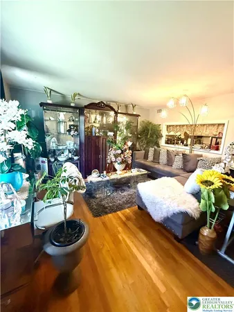 a living room with patio furniture and a potted plant