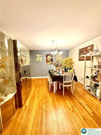 a dining room with furniture and wooden floor