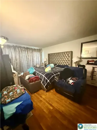 a bedroom with a bed window and couch