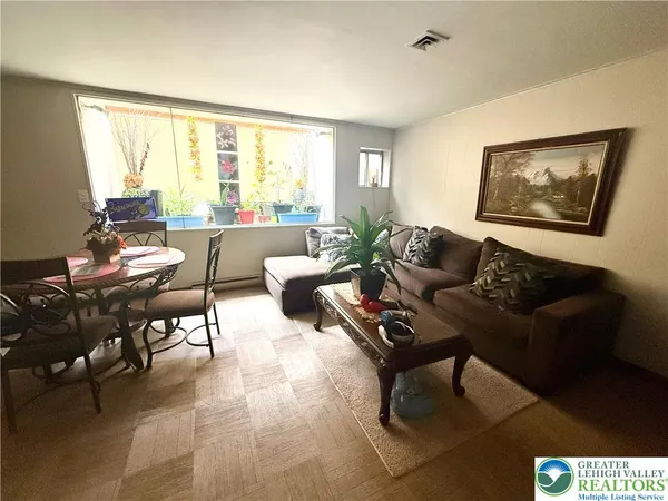 a living room with furniture and a large window
