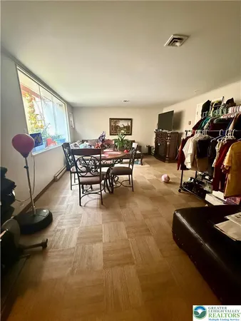 a living room with furniture a rug and a window