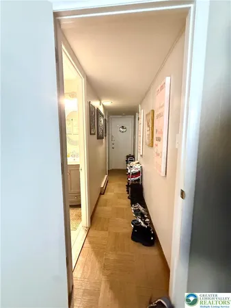 a view of a hallway with a livingroom and furniture