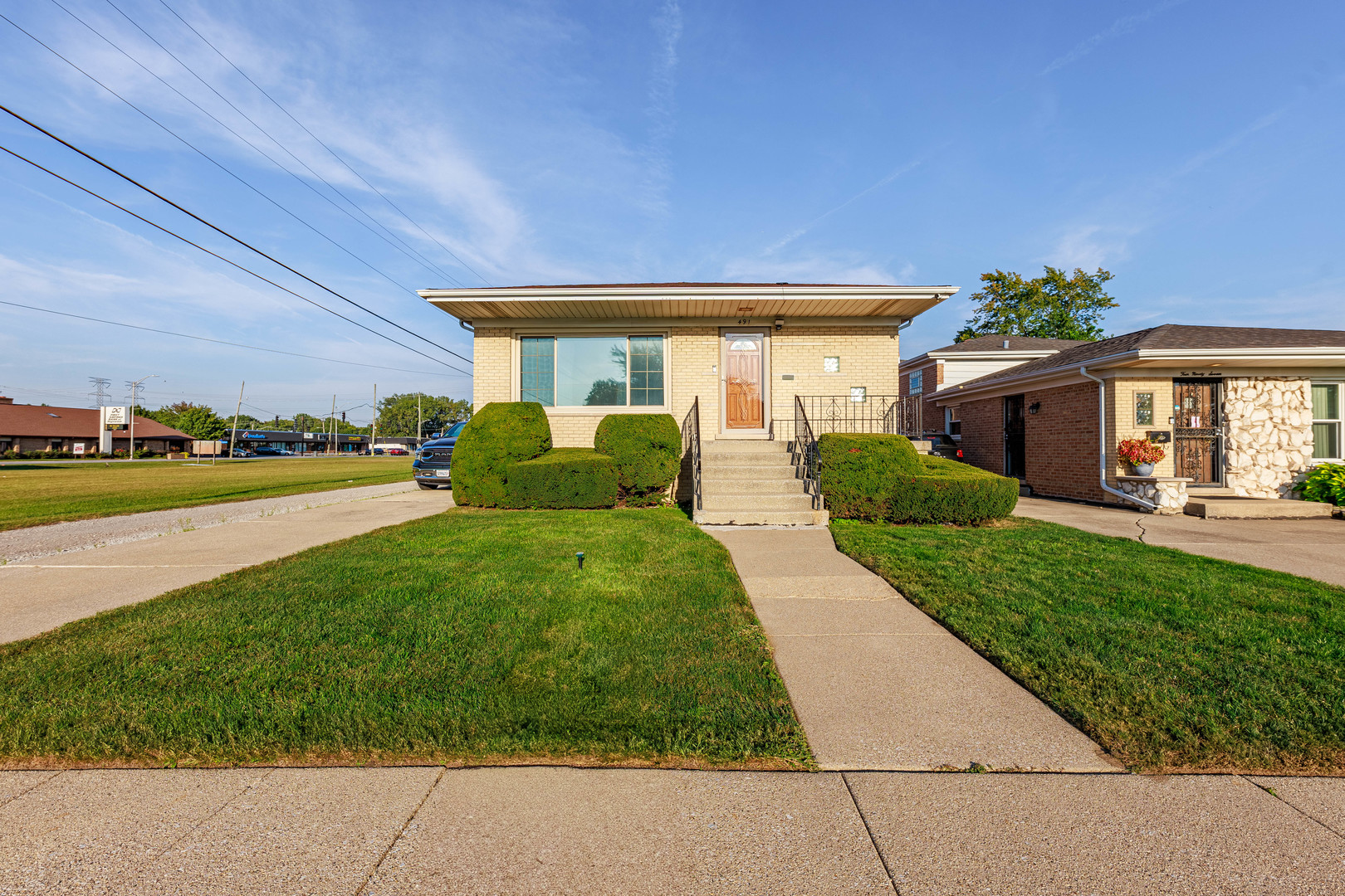491 Escanaba Avenue Calumet City, IL 60409 - Photo 1 of 43 a front view of a house with garden