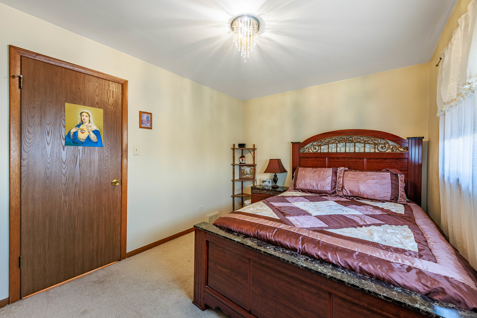 491 Escanaba Avenue Calumet City, IL 60409 - Photo 14 of 43 a bedroom with a bed and a chandelier