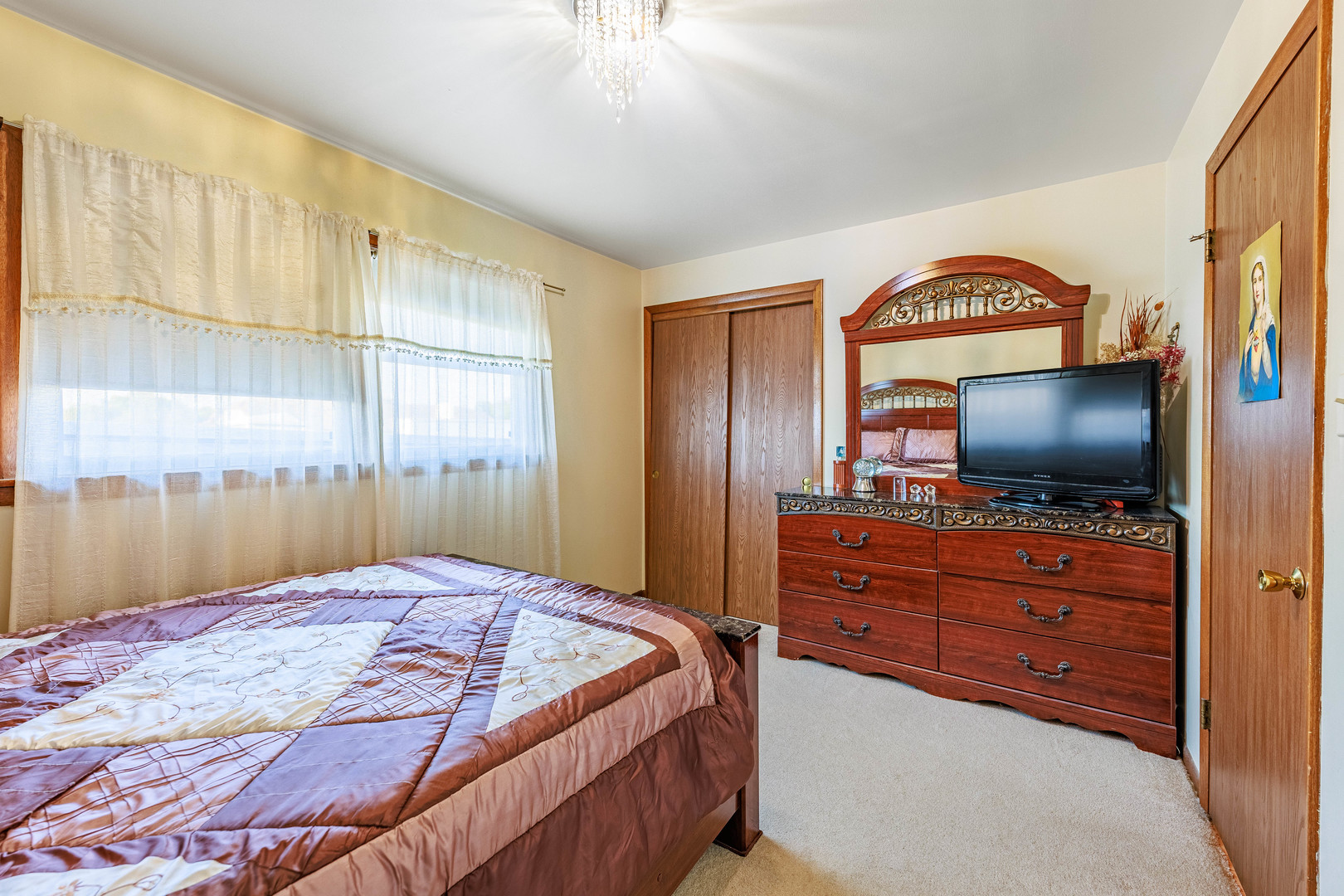 491 Escanaba Avenue Calumet City, IL 60409 - Photo 15 of 43 a bedroom with a bed and a flat screen tv