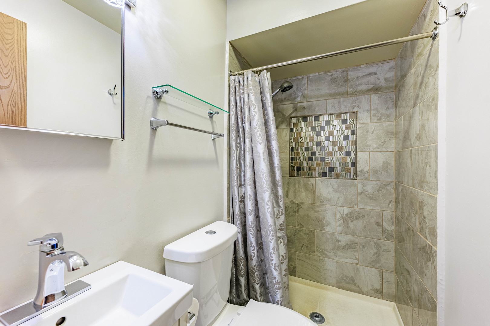 491 Escanaba Avenue Calumet City, IL 60409 - Photo 16 of 43 a bathroom with a shower a toilet and a sink
