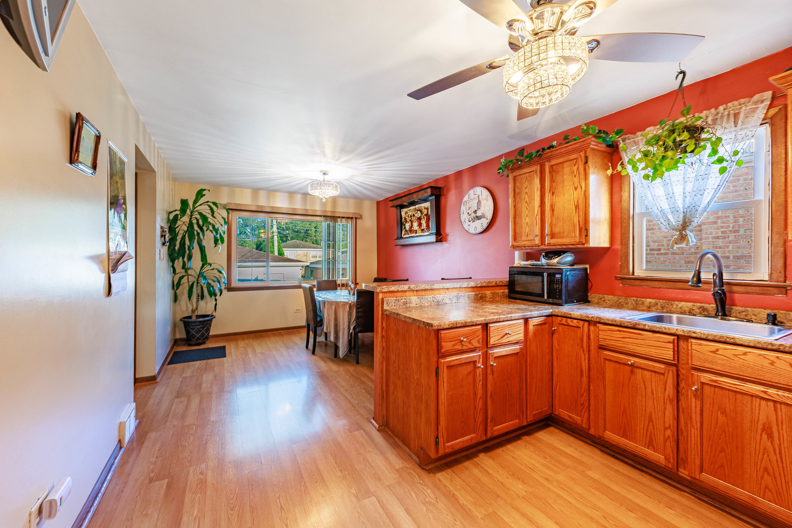 491 Escanaba Avenue Calumet City, IL 60409 - Photo 20 of 43 a kitchen with stainless steel appliances granite countertop a lot of counter space and wooden floors