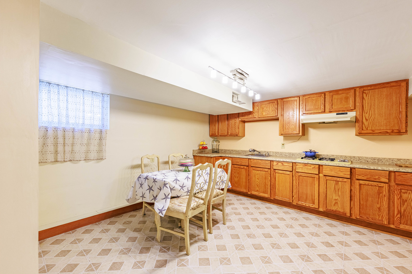 491 Escanaba Avenue Calumet City, IL 60409 - Photo 37 of 43 a kitchen with granite countertop sink window and white cabinets