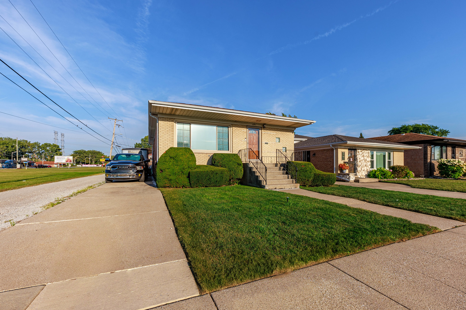 491 Escanaba Avenue Calumet City, IL 60409 - Photo 8 of 43 a front view of a house with a yard and potted plants