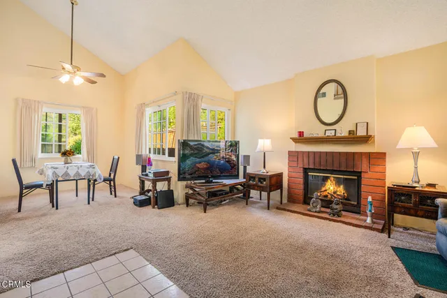 a living room with furniture a fireplace and a chandelier