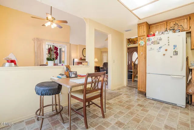 a kitchen with stainless steel appliances a refrigerator and a table