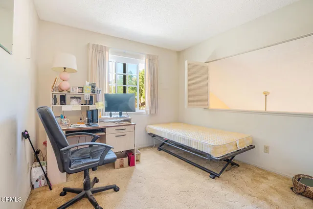 a bedroom with a workspace