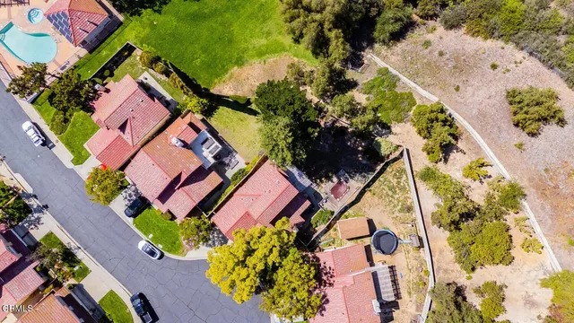 an aerial view of a house with a yard and garden