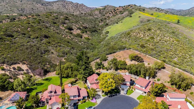 an aerial view of a residential houses with outdoor space