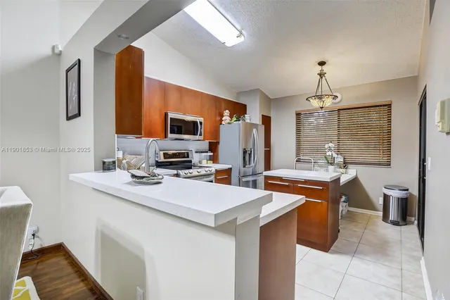 a kitchen that has a sink and a stove in it