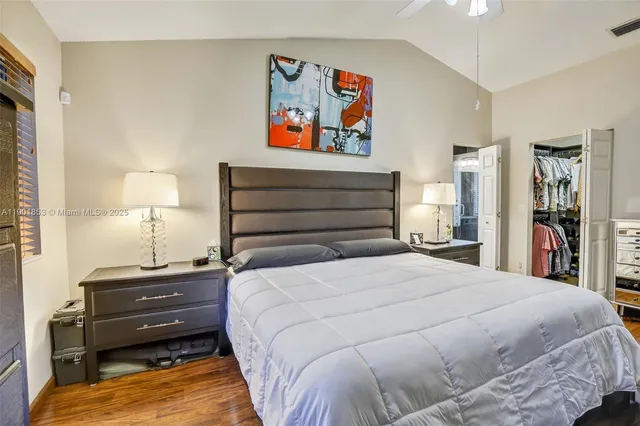 a bedroom with a bed and wall painting